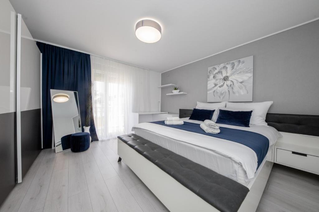 a bedroom with a large bed with blue and white at Apartmani Mery in Rab