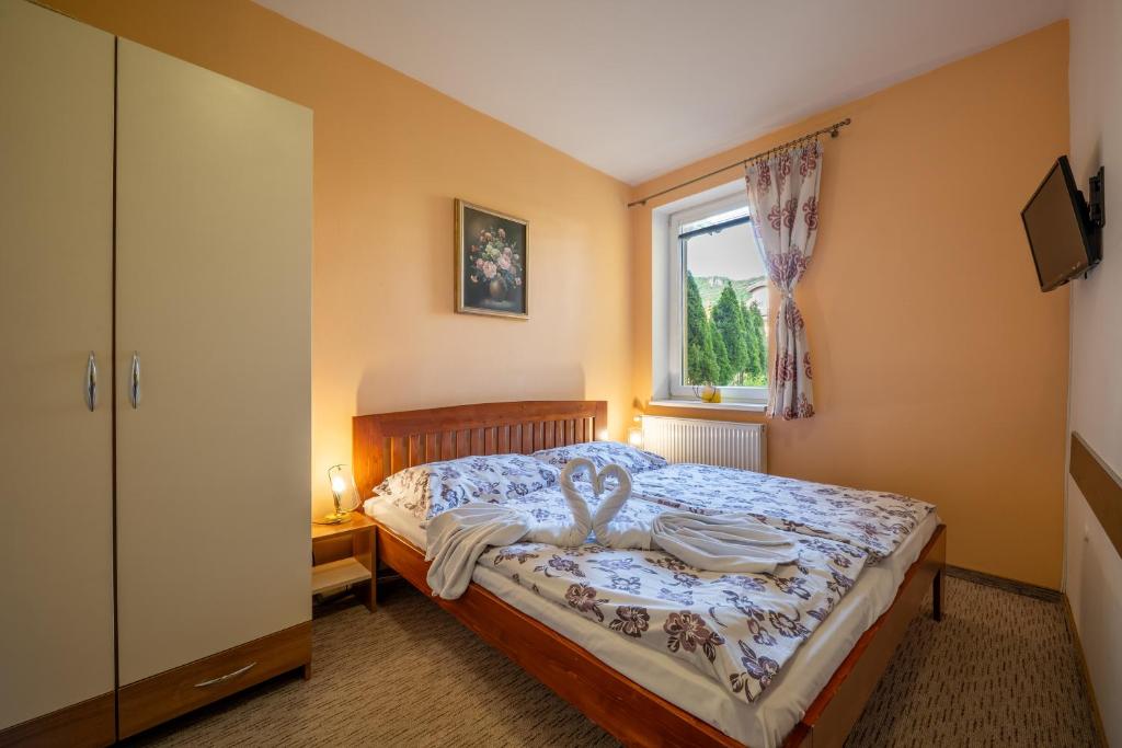 Postel nebo postele na pokoji v ubytování Penzion Raj