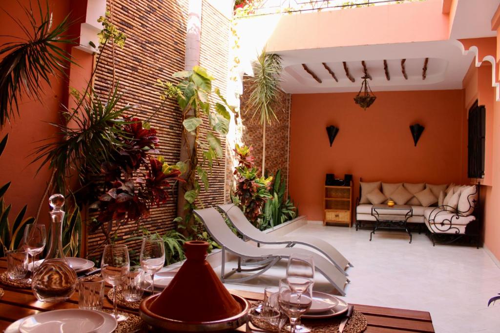 a patio with a table and chairs and a couch at Seaside 2 Bedrooms Villa - IMI OUADDAR in Agadir