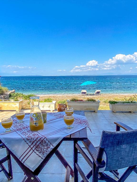 a picnic table with a view of the ocean at Kyparissis Beach house 1 in Lésvos