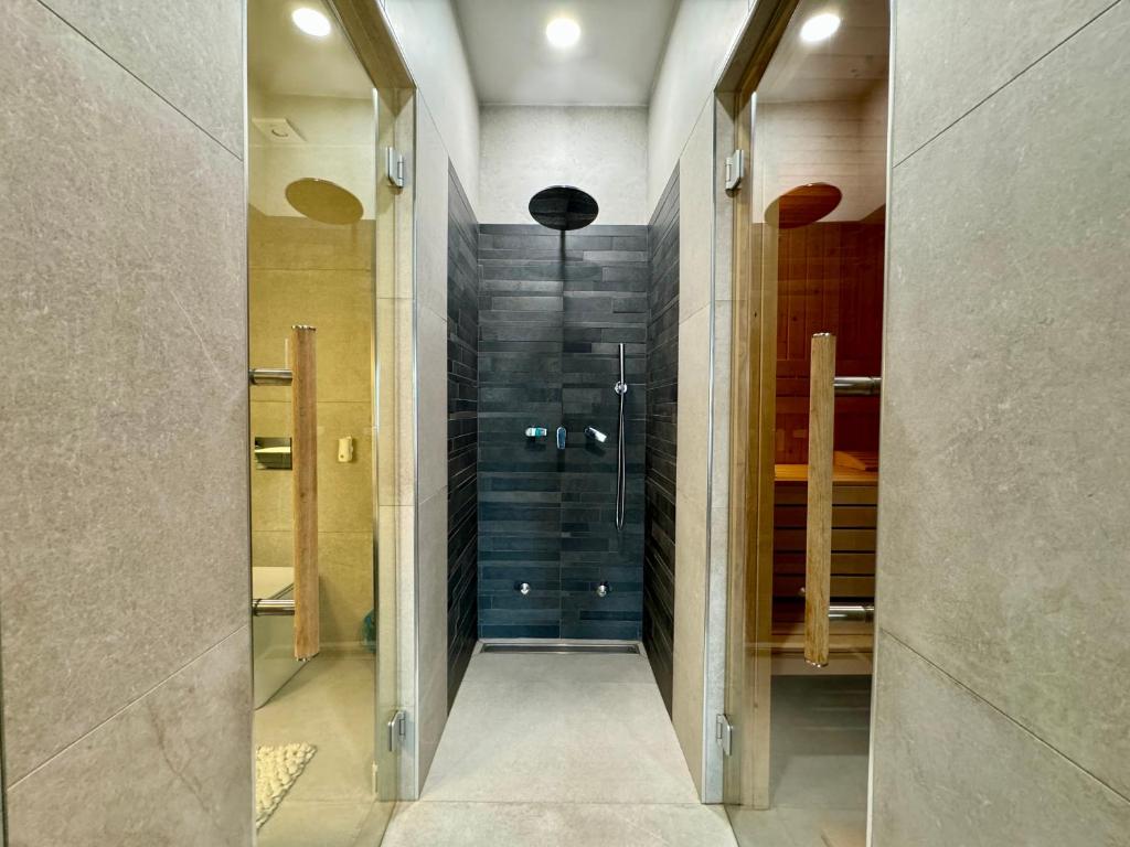 a bathroom with a shower and a walk in closet at Sauna y in Cluj-Napoca