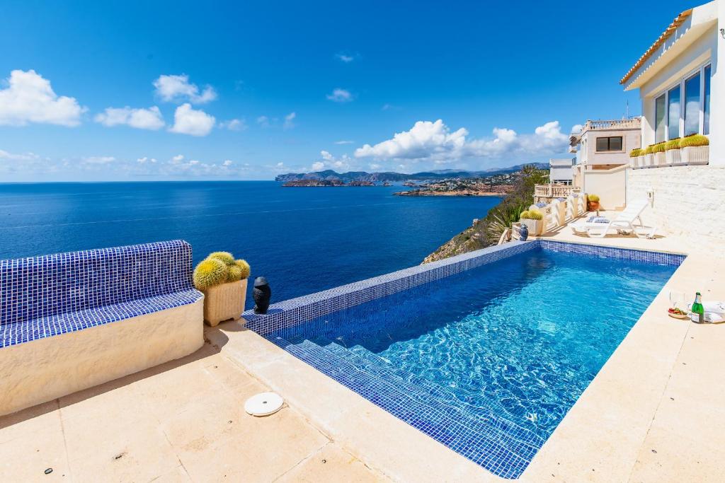 a swimming pool with a view of the ocean at Villa Maravilla by Mallorca Infinity in El Toro