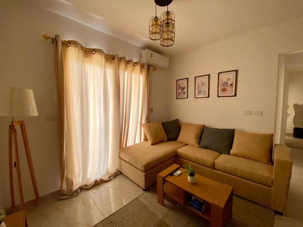 a living room with a couch and a table at Cairo Madinty 2 in Madinaty