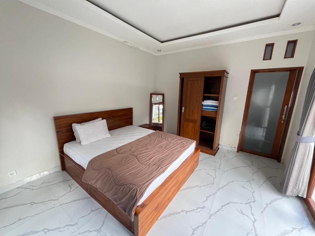 a bedroom with a bed in a room at D Teba Ubud Villa in Ubud