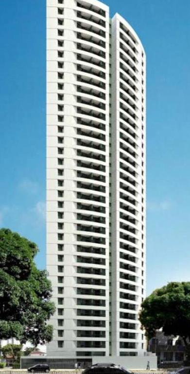 a tall white building with a lot of windows at Flat Rosarinho Essence in Recife