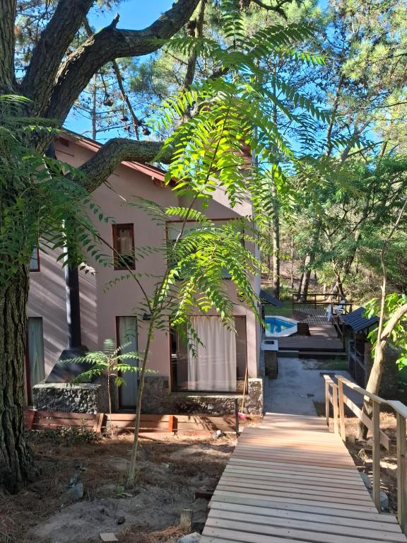 a house with a wooden walkway in front of it at Loft 35 metros cuadrados in Mar de las Pampas