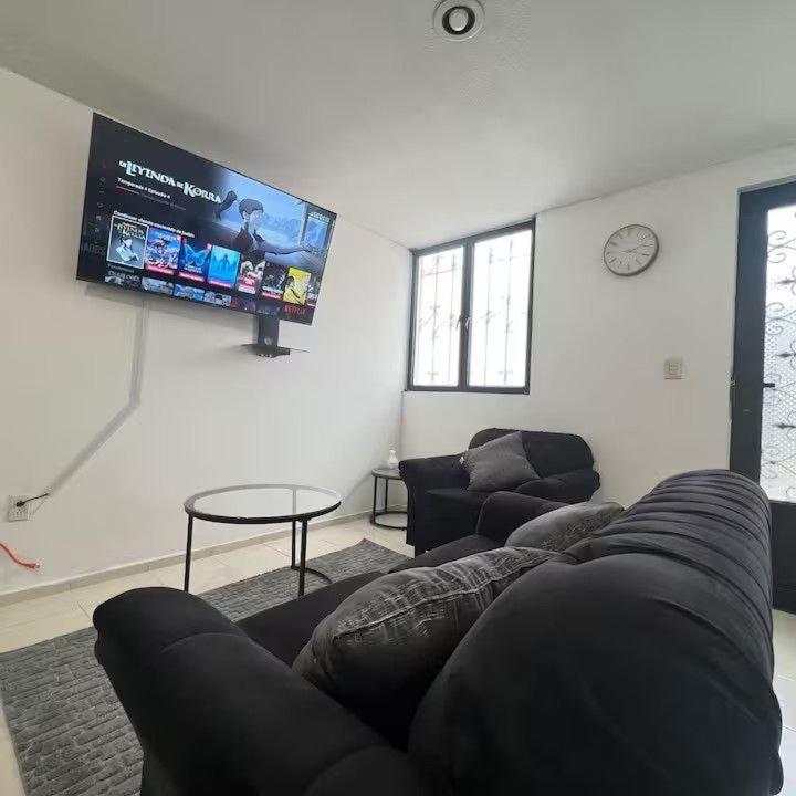 a living room with a couch and a flat screen tv at Casa en Tehuacán Se puede facturar in Cedro