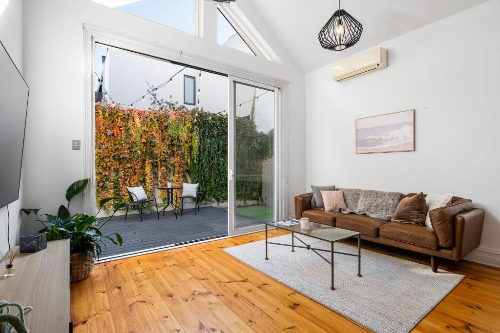 a living room with a couch and a table at Portside by Property Mums in Melbourne