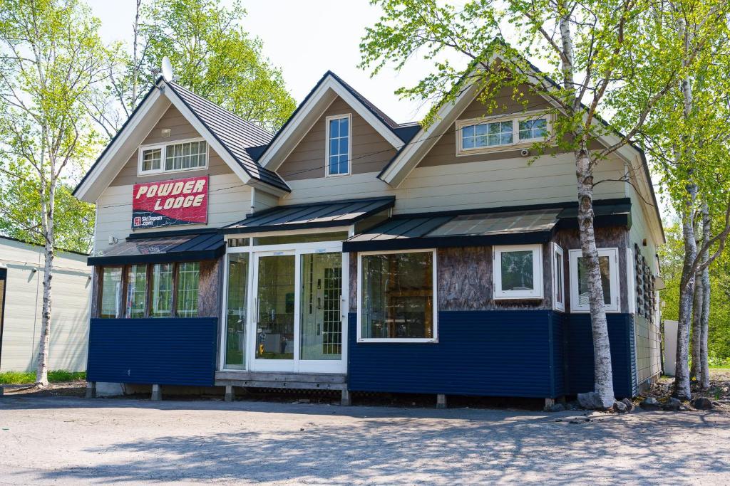 a blue and white building with a store at Rusutsu Powder Lodge in Rusutsu