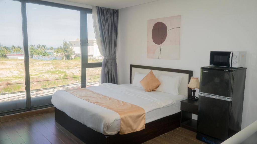 Postel nebo postele na pokoji v ubytování Horizon Front Beach Hotel Danang