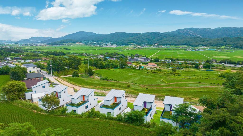 an aerial view of a village with houses in a field at Gyeongju Gamseong The Glamping Pool Villa in Gyeongju