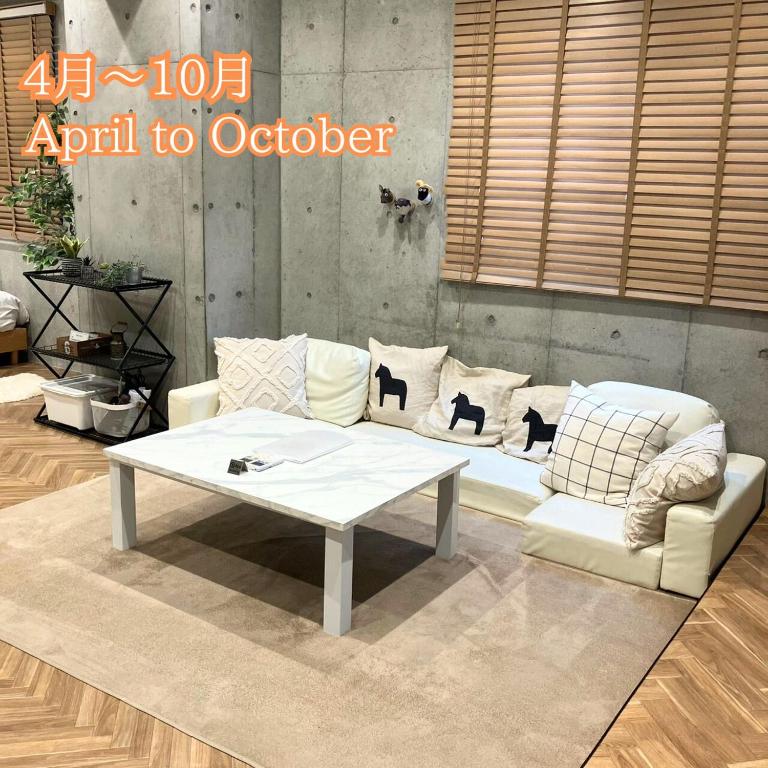 a living room with a couch and a coffee table at 原田屋Hotel 3F in Tokyo
