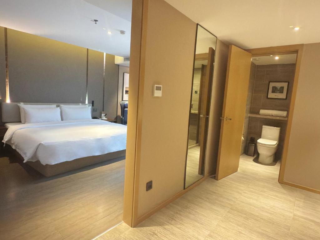 a hotel room with a bed and a bathroom at Atour Hotel Chengdu Wenshufang in Chengdu