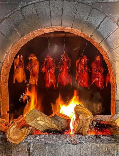 a brick oven with food cooking in it at base-Beijing Wangfujing Serviced Apartment- in Hutong &Bike rental &Close to Forbidden City, Tian'anmen Square &Subway nearby &Free coffee &Washing machine,Kitchen &Restaurant discount &English speaking &High speed free WiFi in Beijing