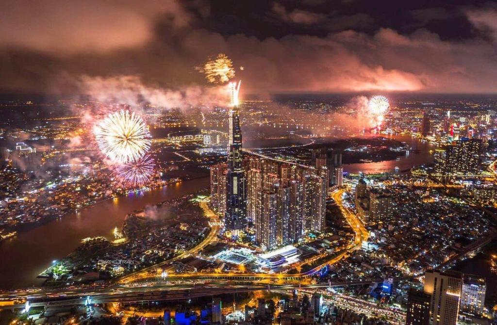 an aerial view of a city at night with fireworks at LUNA Apartment - Luxury Residence Landmark 81 Area in Ho Chi Minh City