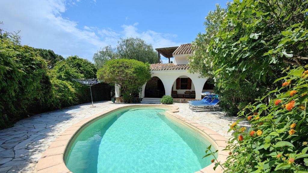 a swimming pool in front of a house at Villa Acquario in Torre delle Stelle