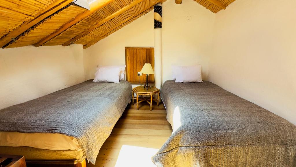 Postel nebo postele na pokoji v ubytování ARQUEOLOGO Exclusive Boutique Hotel Cusco - Centro Histórico