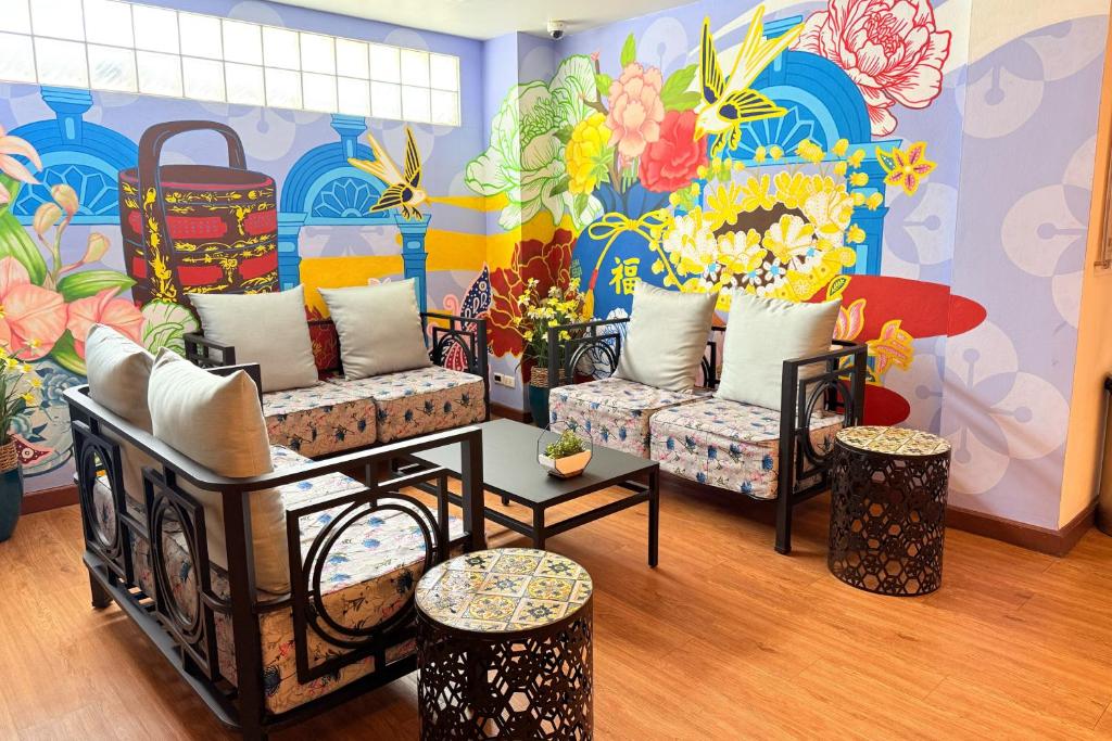 a room with couches and a mural of flowers at Days Inn by Wyndham Patong Beach in Patong Beach