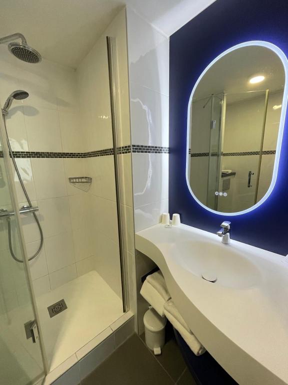 a bathroom with a shower and a sink and a mirror at Best Western Hôtel Royan Océan in Royan