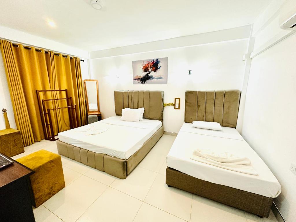 Postel nebo postele na pokoji v ubytování Ismattha Hotel