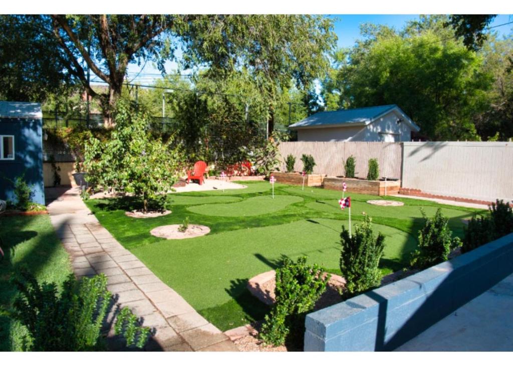 a backyard with a golf course in the yard at Single Story 3BR Downtown Oasis Hot Tub Mini Golf Premium Amenities in St. George