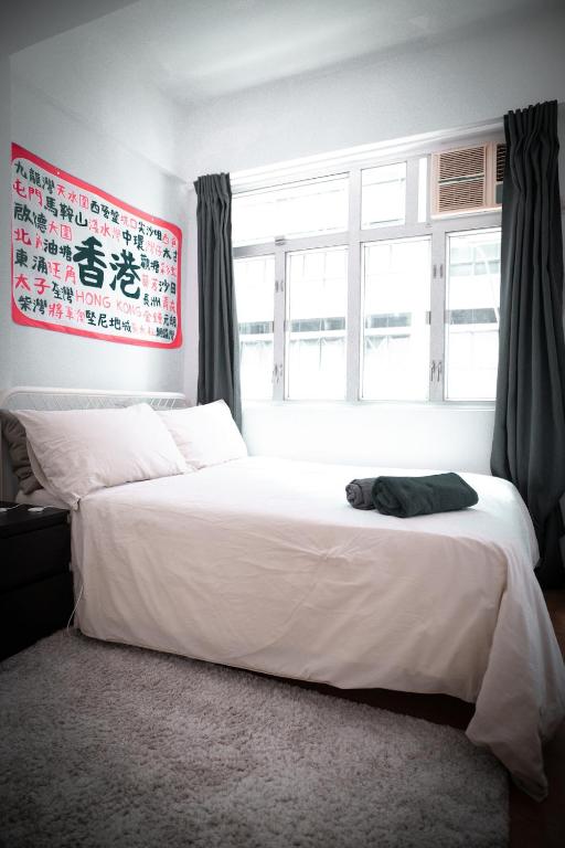 Postel nebo postele na pokoji v ubytování Cozy flat in Hong Kong
