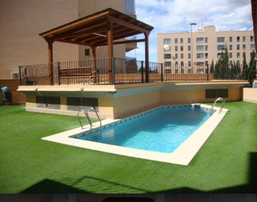 a swimming pool with a gazebo on a building at TODO INCLUIDO - Wifi,playa,piscina 24h,garaje,terraza y Mercadona -MUY CÓMODO in Canet de Berenguer
