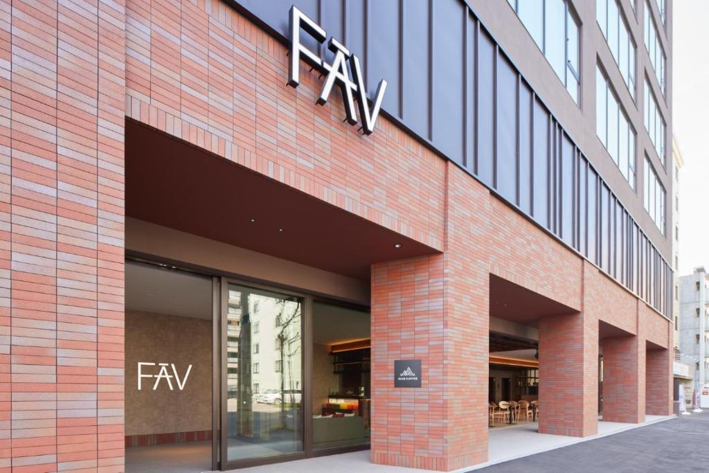 a building with a sign on the side of it at FAV LUX Sapporo Susukino in Sapporo