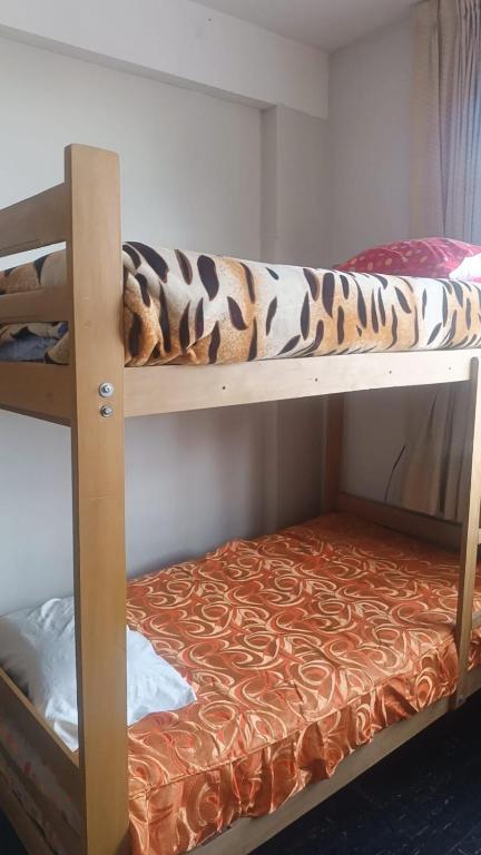 Postel nebo postele na pokoji v ubytování Hostal wayki