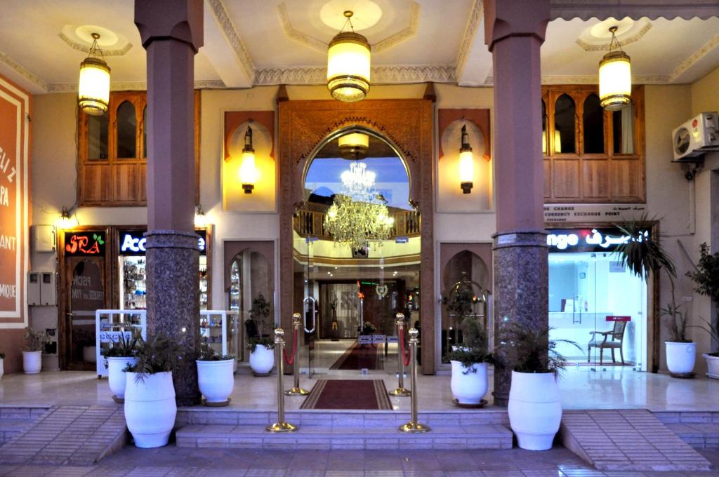 a lobby with columns and plants in a building at Mont Gueliz in Marrakesh