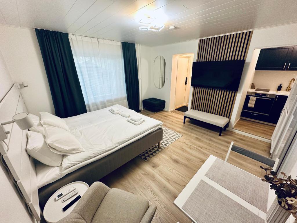 a bedroom with a bed and a couch in a room at Katariina Apartments in Kotka