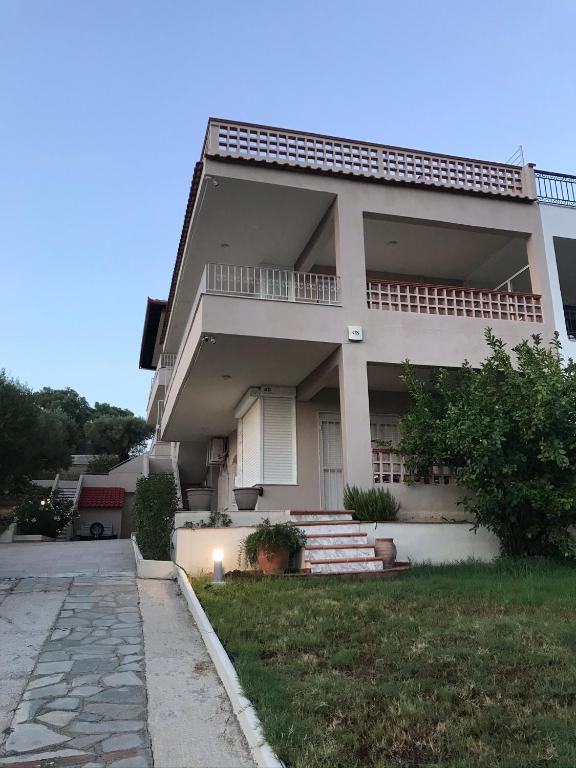 a large house with a walkway in front of it at OLIVE&VIEW in Nea Moudania