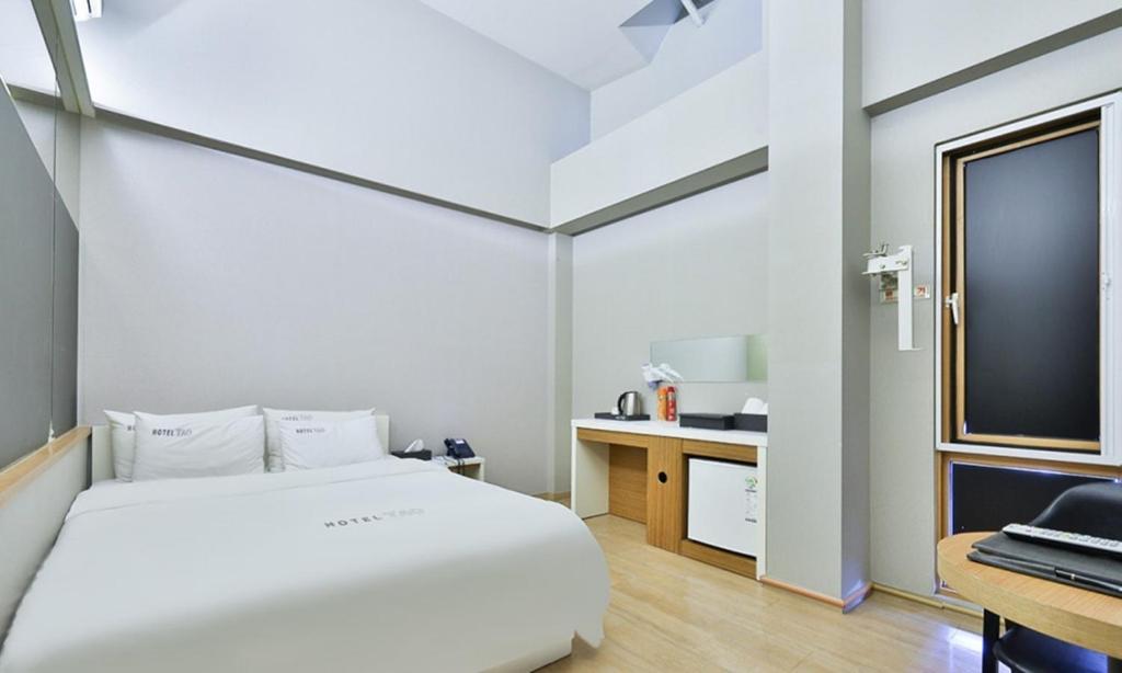 Postel nebo postele na pokoji v ubytování Hotel TAO