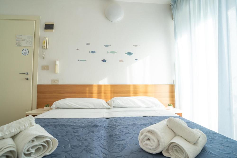 Postel nebo postele na pokoji v ubytování Hotel Kelly