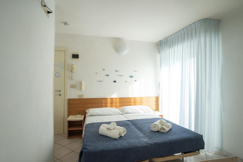 Postel nebo postele na pokoji v ubytování Hotel Kelly