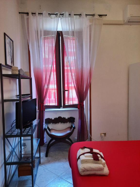 a living room with a red couch and a window at Casa Dorianna in Rome