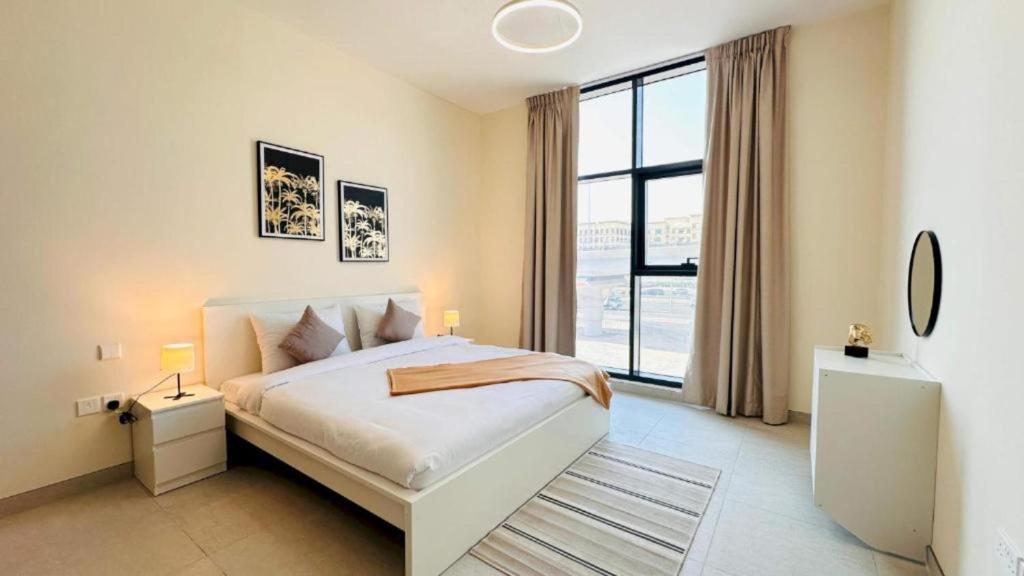 a bedroom with a bed and a large window at Luxurious apartments at JLT by Checkmyguest in Dubai