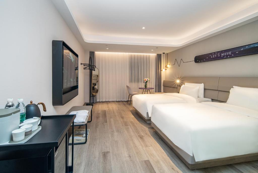 Postel nebo postele na pokoji v ubytování Atour Light Hotel Shanghai Xujiahui Jiaotong University