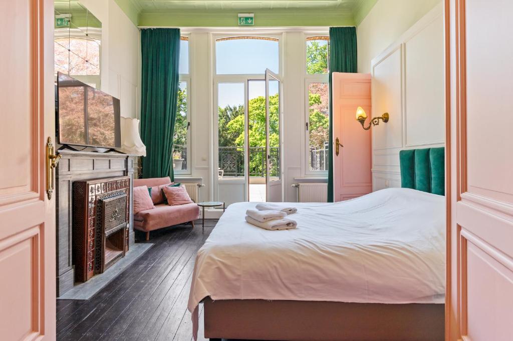 een slaapkamer met een bed en een open haard bij B&B Baron Osy Suite Terrace in Antwerpen
