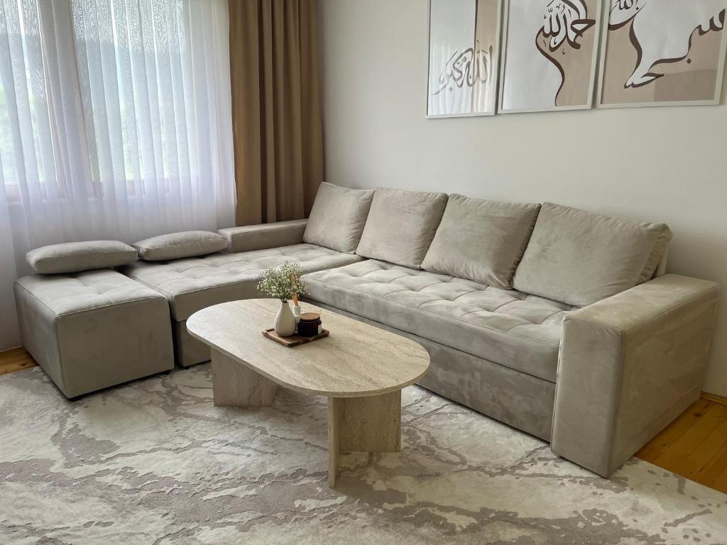 a living room with a couch and a table at Butmir house-Sarajevo in Ivišovo Greblje
