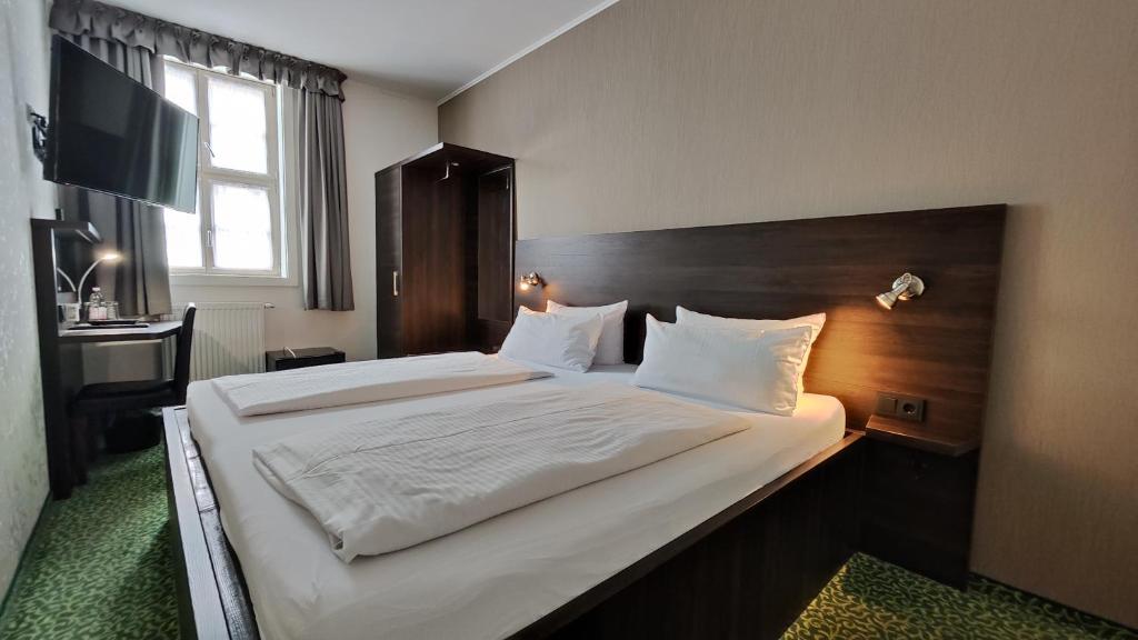 Postel nebo postele na pokoji v ubytování Hotel Alte Brennerei