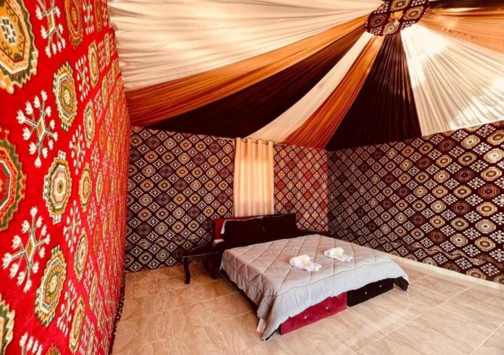 a bedroom with a bed in a tent at Wadi rum sand Delight camp in Wadi Rum