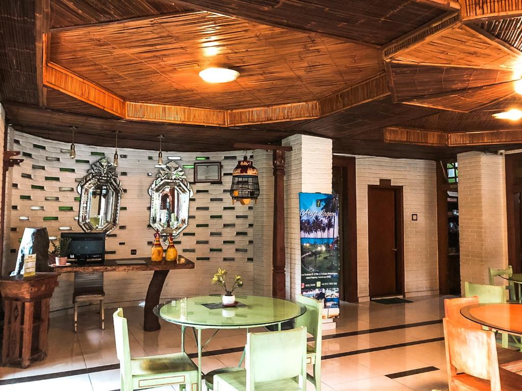 a dining room with a table and chairs at Arys Garden Hotel Yogyakarta in Yogyakarta