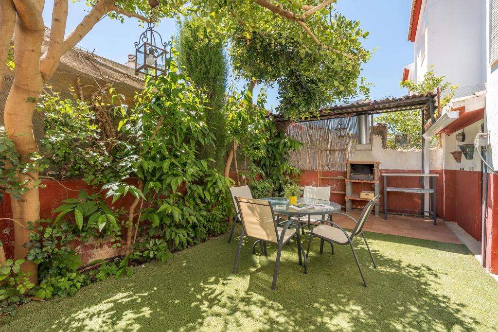 eine Terrasse mit einem Tisch und Stühlen im Garten in der Unterkunft La Era de Alcántara in Cónchar