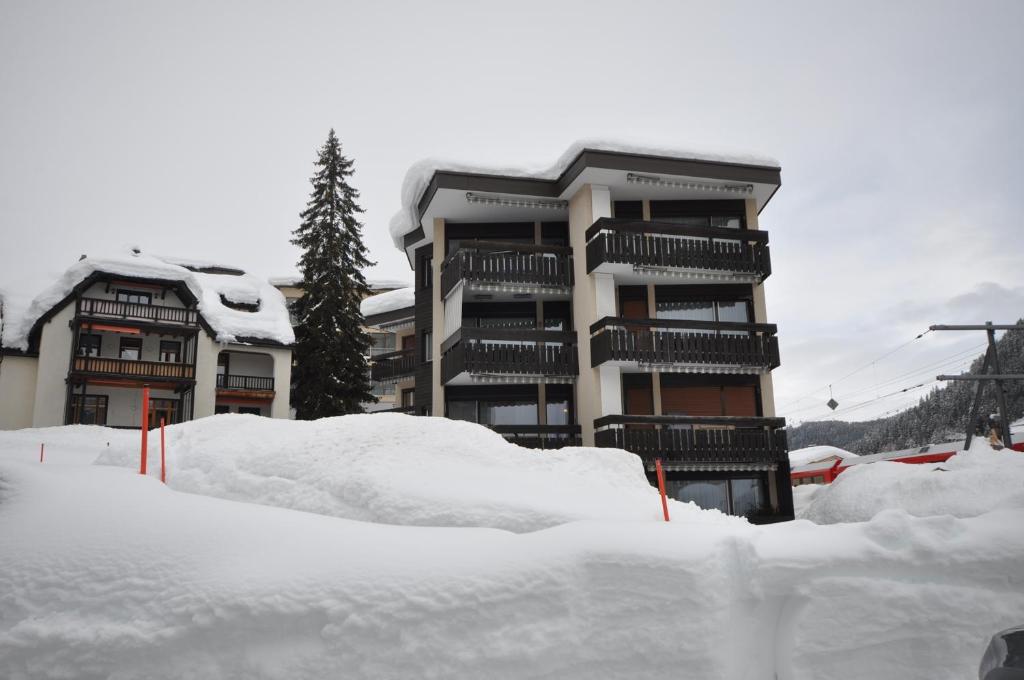 a pile of snow in front of a building at 1-Zi Appartement Ladina Davos in Bolgen