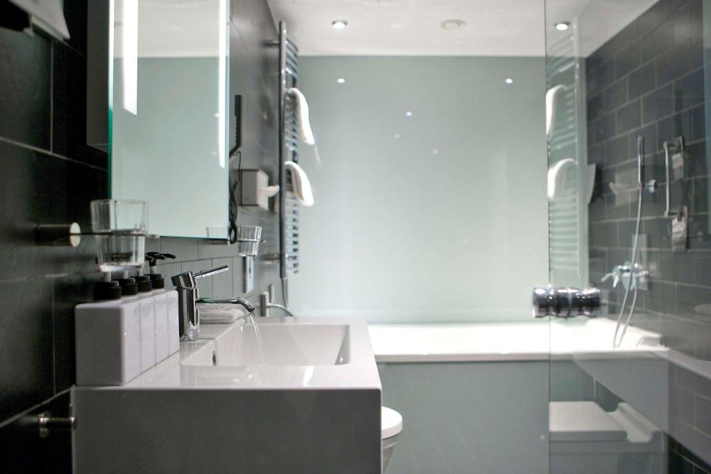 a bathroom with a sink and a toilet at Scandic Palace Hotel in Copenhagen