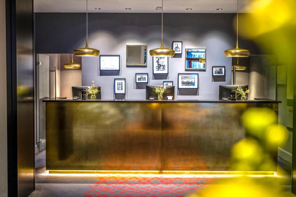a reception counter in a room with pictures on the wall at Scandic Palace Hotel in Copenhagen
