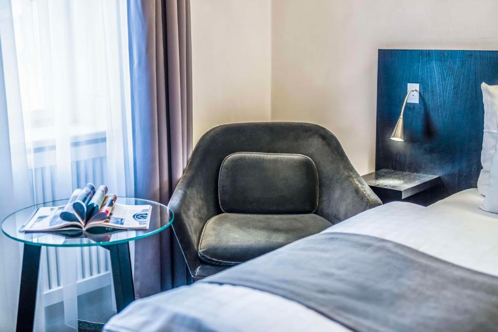 a hotel room with a chair and a bed at Scandic Palace Hotel in Copenhagen