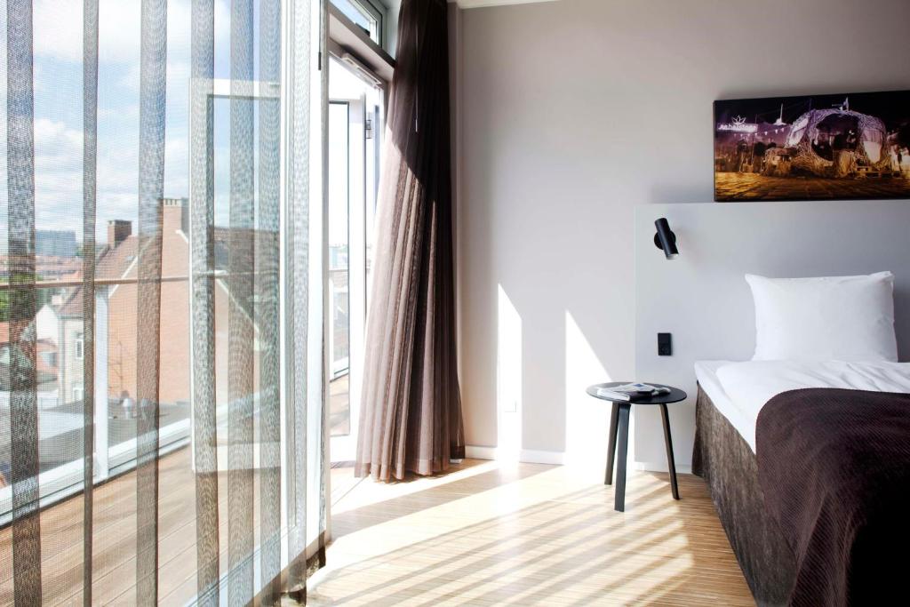 Postel nebo postele na pokoji v ubytování Scandic Aarhus City