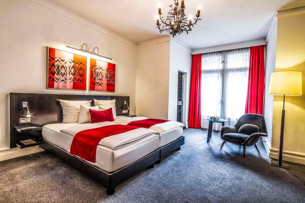 a bedroom with a large bed and a chair at Scandic Palace Hotel in Copenhagen
